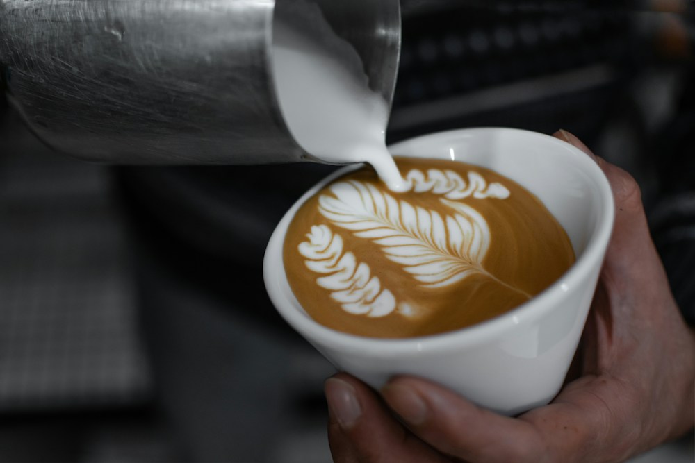 Milk being poured into a cappuccino